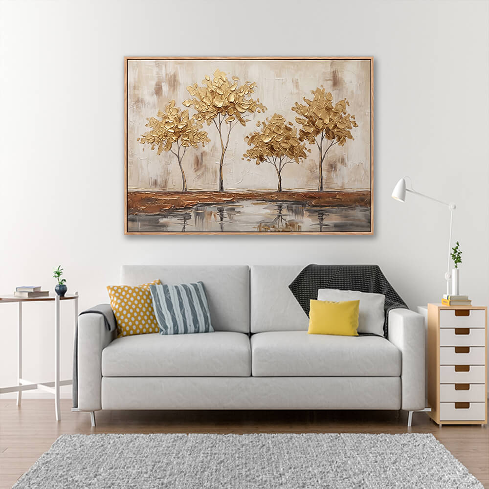 Hand painted golden trees landscape above grey sofa with yellow accent pillows