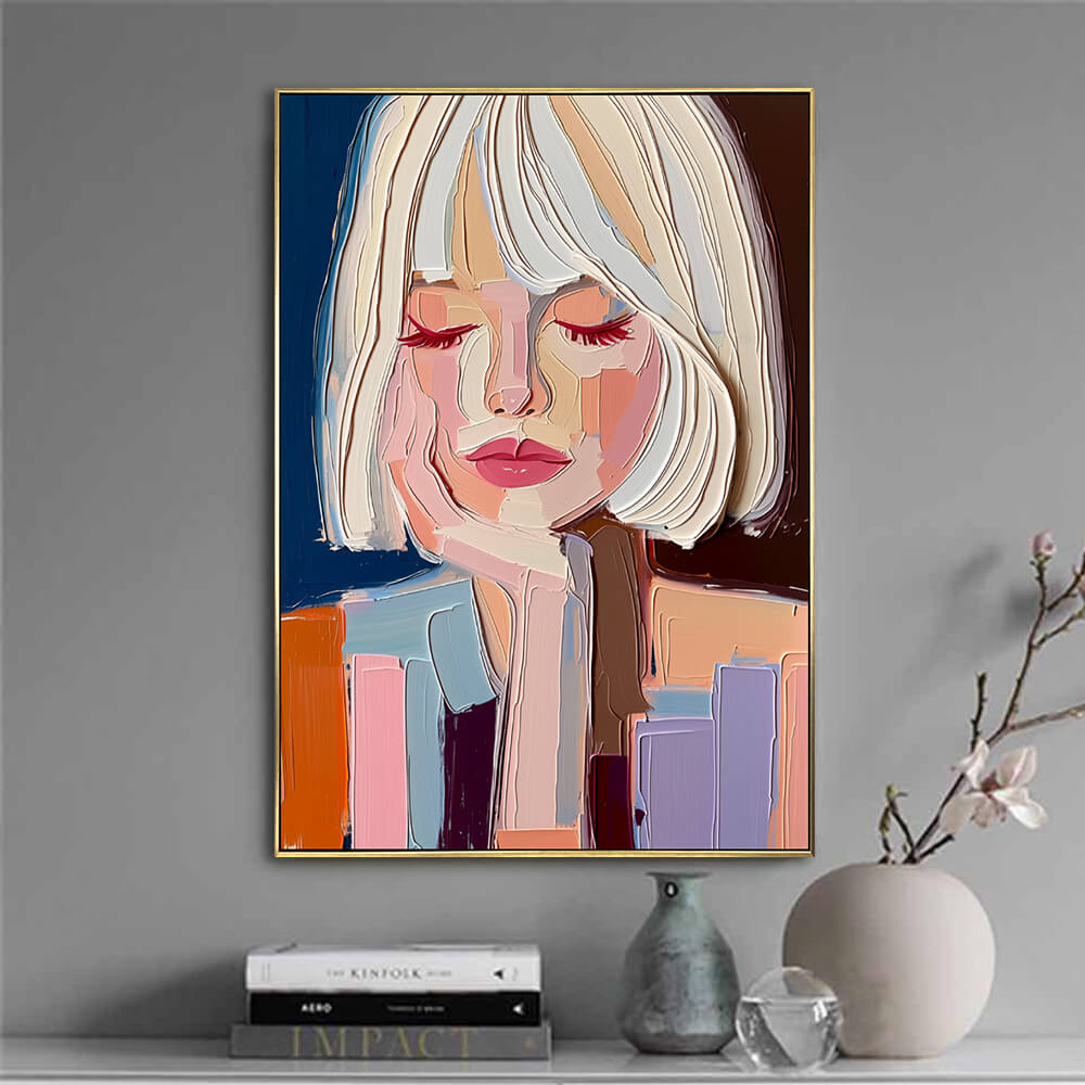 Hand-painted modern art canvas featuring a stylish female portrait styled on a gray accent wall with modern decor books.