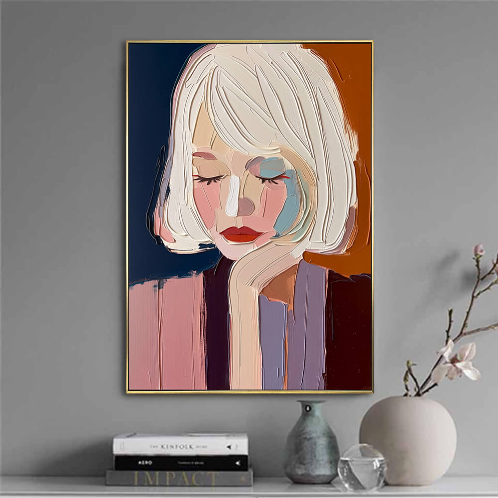 Hand-painted modern art canvas featuring a stylish female portrait styled on a gray accent wall with modern decor books.