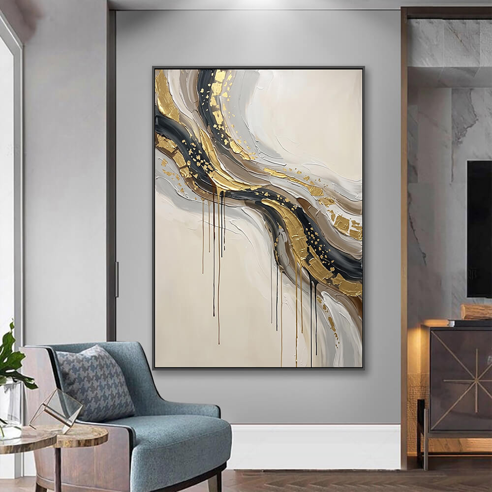 Vertical metallic abstract artwork hung in entryway beside upholstered accent chair