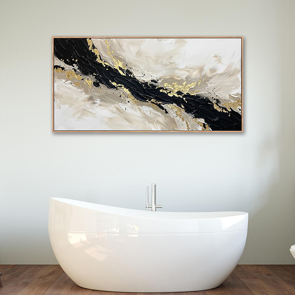 Large panoramic black and gold abstract painting decorating the wall above a modern freestanding white bathtub.