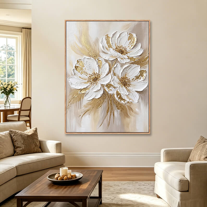 Vertical textured white flower painting with gold leaf accents in elegant living room, heavy impasto canvas above cream sofa