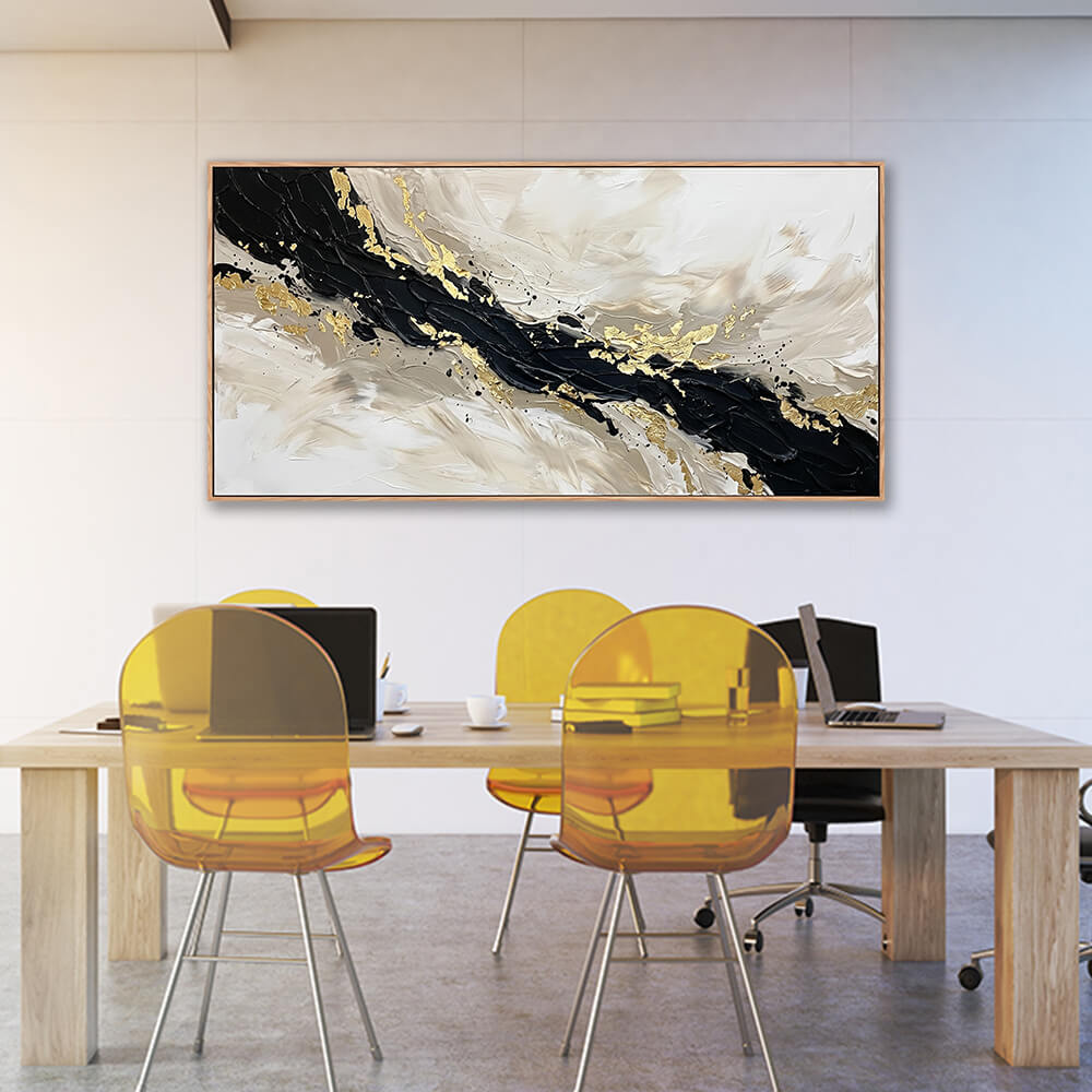 Wide horizontal black and gold textured abstract painting displayed in a bright modern office above a desk with yellow chairs.