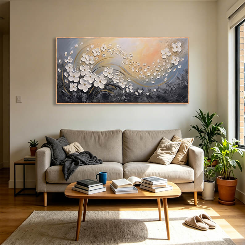 Shimmering gold and white textured floral abstract canvas framed and displayed on a warm beige wall.