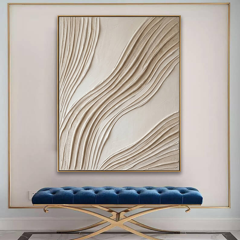 Modern textured wave canvas art displayed prominently above a tufted blue velvet bench in an elegant entryway.
