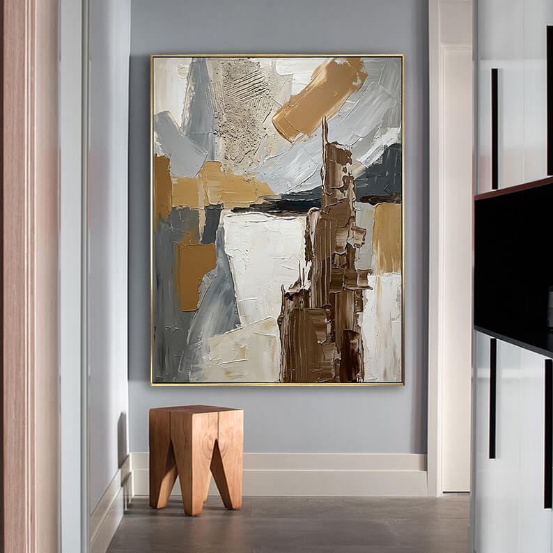 Abstract geometric 3D texture painting hanging above a geometric wooden stool in a minimalist modern hallway.