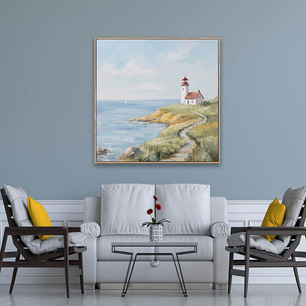 Soft cliffside lighthouse coastal landscape artwork hanging on light blue formal living room wall