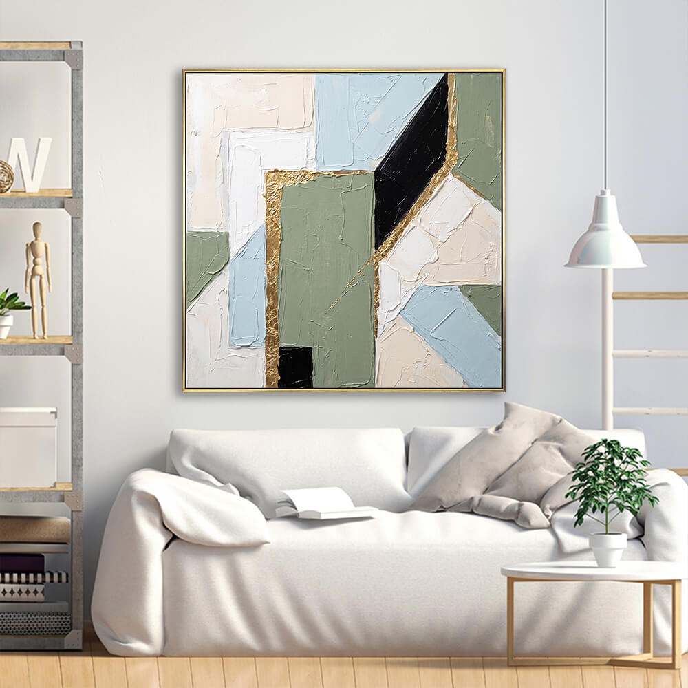 Muted sage geometric gold foil abstract canvas above cream linen minimalist Scandinavian sofa