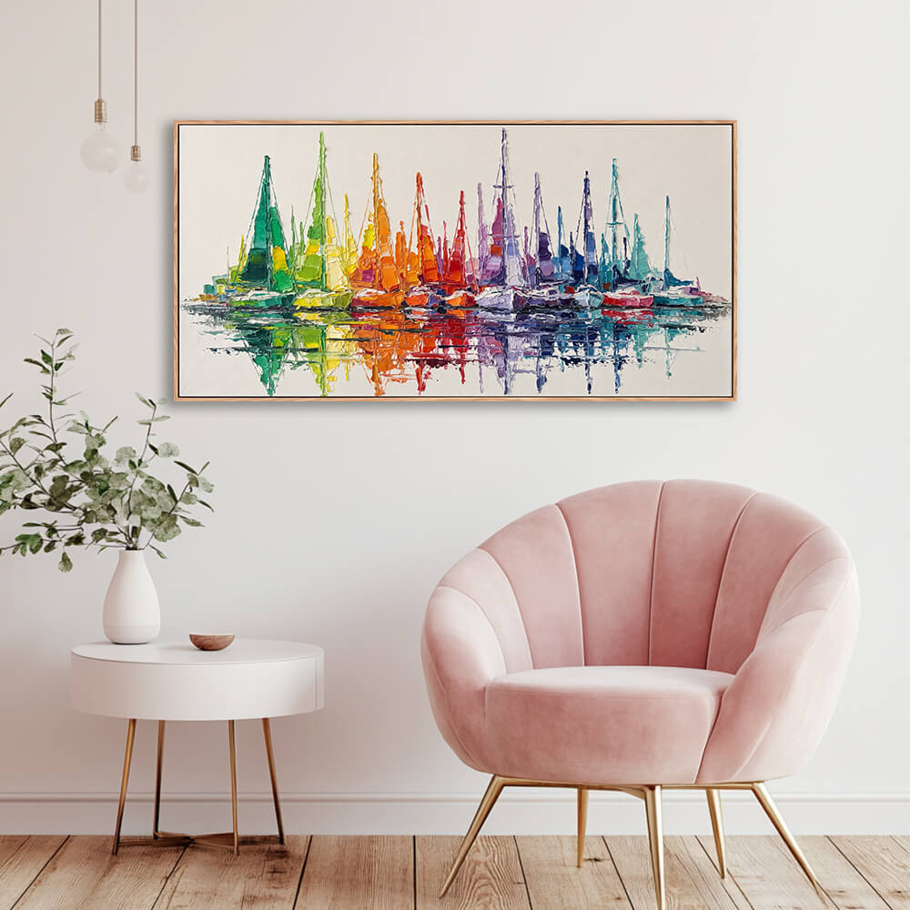 Wide rainbow harbor sailboat seascape artwork installed beside velvet accent chair for corner wall styling