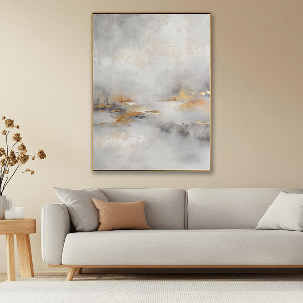 Neutral misty gold leaf abstract canvas artwork above light wood frame sofa in warm natural japandi interior