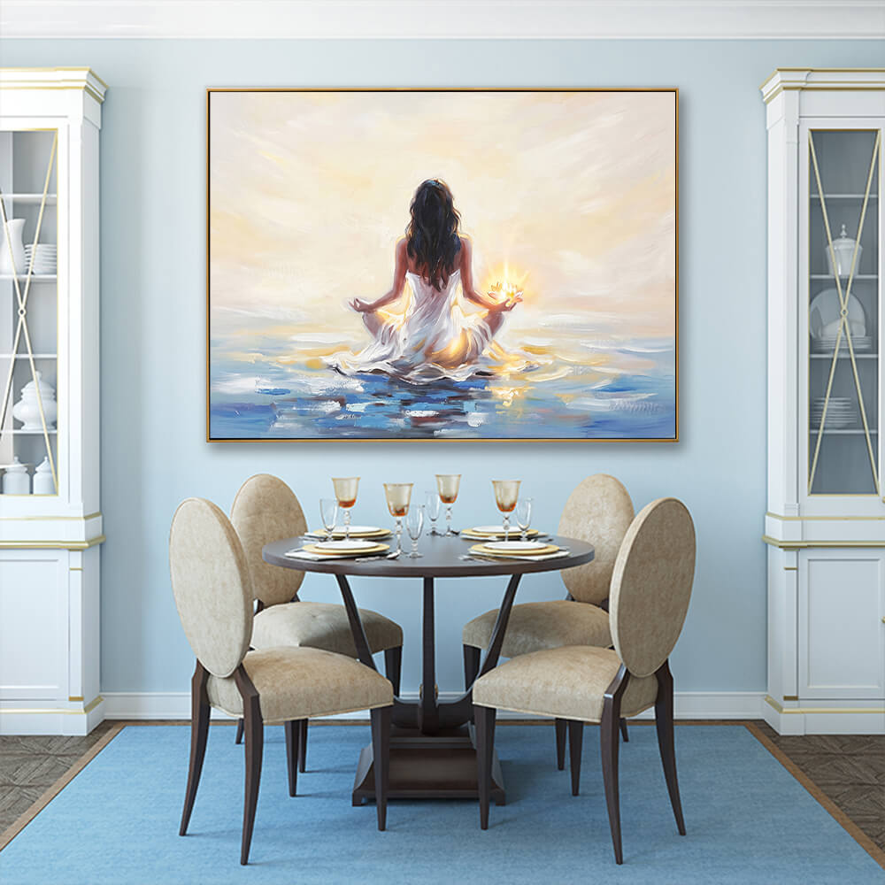 Hand-painted meditation woman lotus seascape canvas above round dining table with beige upholstered dining chairs