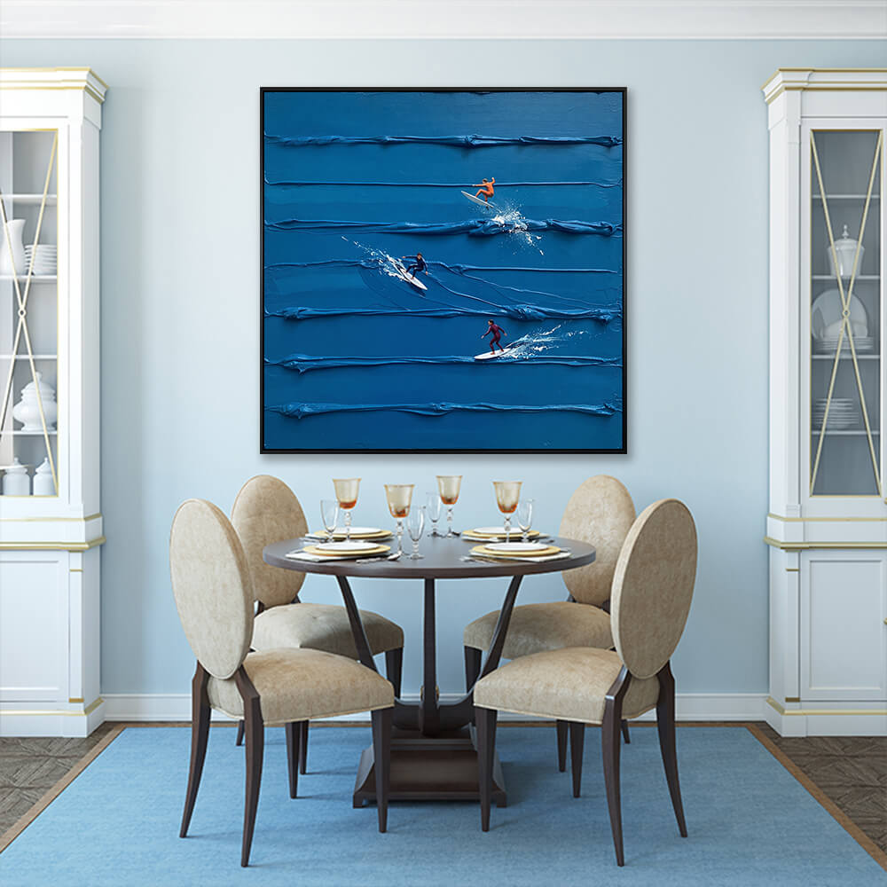 Interior styling view of Azure Surf Break hanging in a blue-walled dining room above a dark wood table set with beige chairs.
