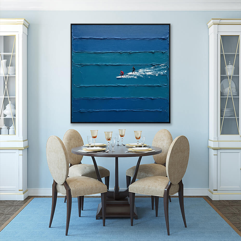 Interior styling view of Coastal Glide hanging in a blue-walled dining room above a dark wood table set with beige chairs.
