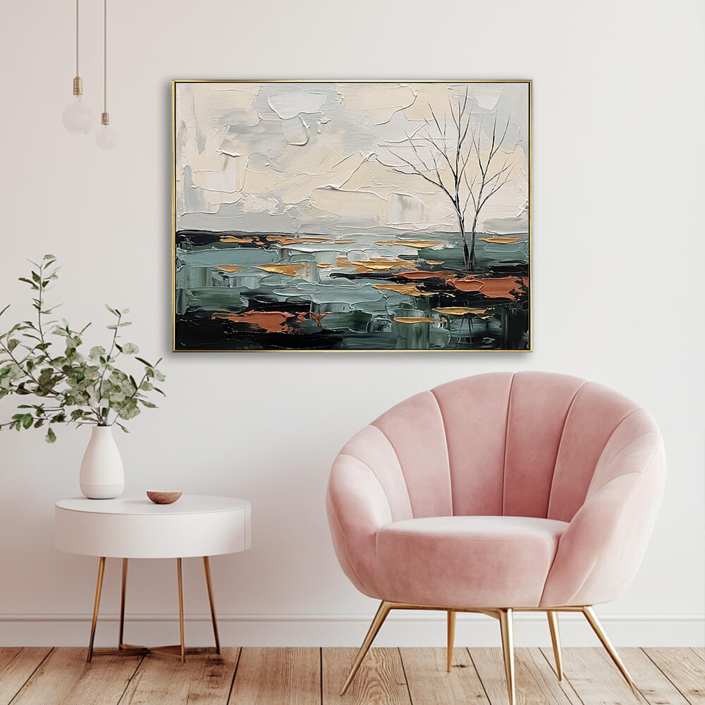 Hand-painted teal landscape canvas painting in an elegant seating nook with a blush pink velvet chair and gold legs