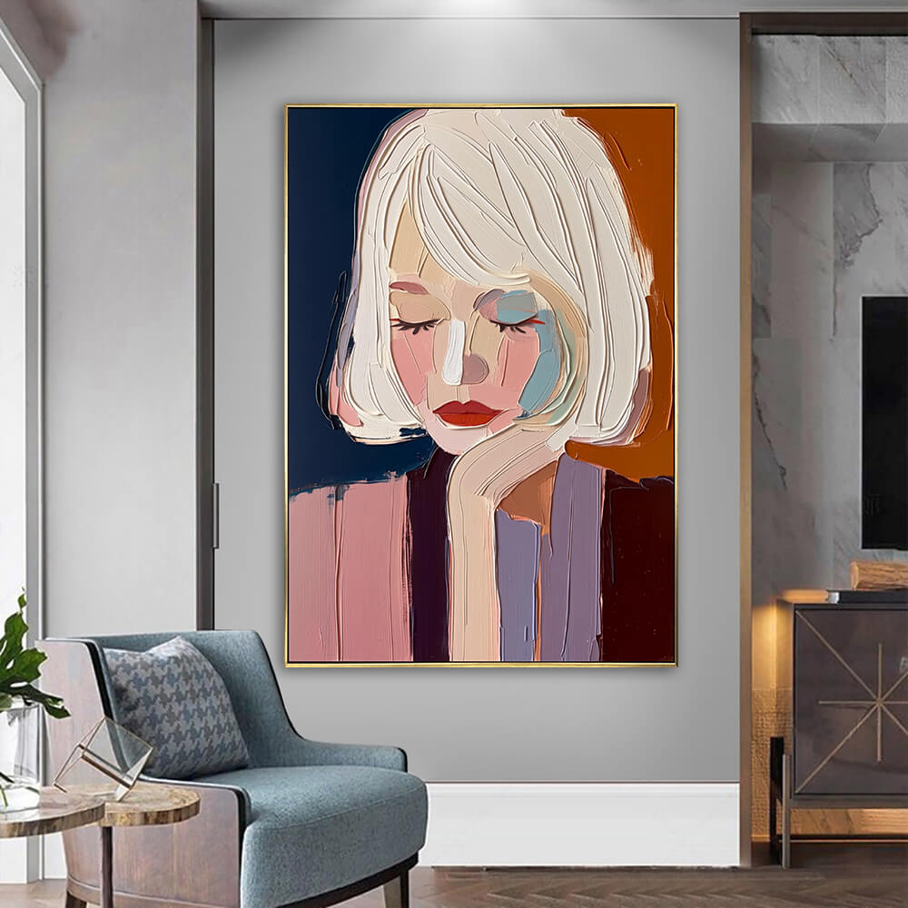 Textured palette knife portrait canvas art hanging on a neutral wall next to a cozy modern armchair and side table.