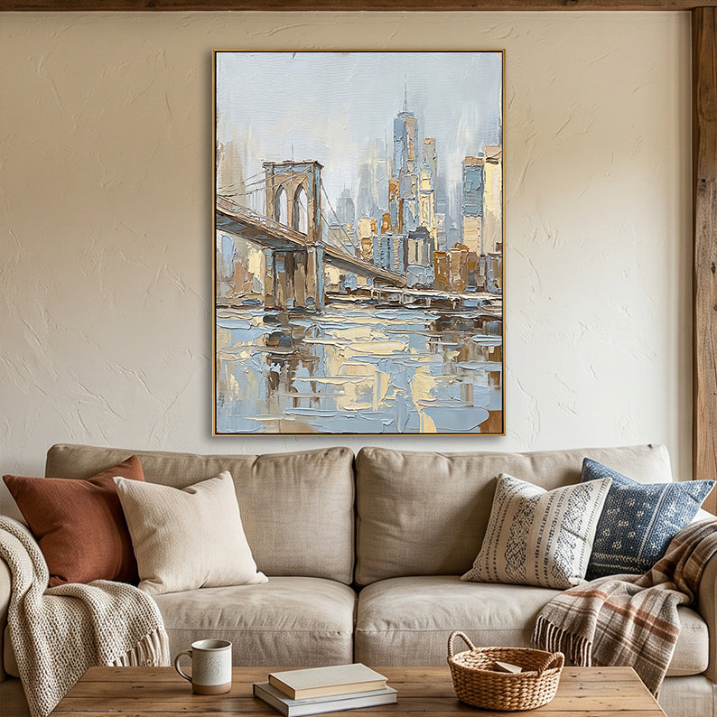 Hand-painted NYC skyline art hanging above a beige sofa in a cozy living room with earth-toned pillows.