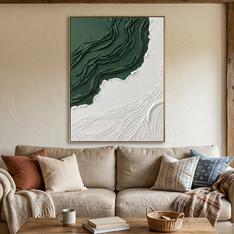Large 3D forest green and white abstract relief art hanging above a beige sofa in a modern living room.