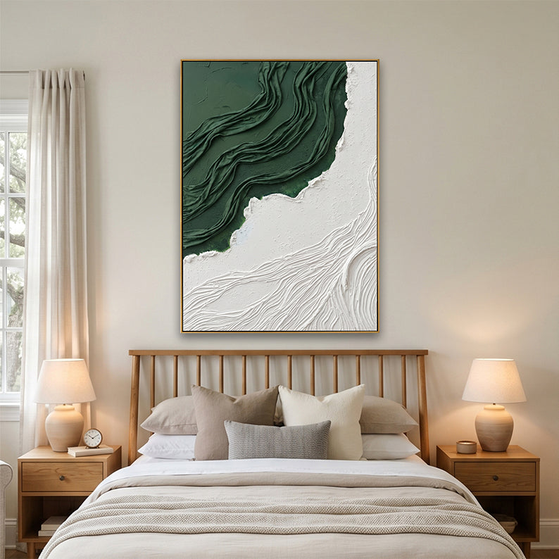 Modern minimalist bedroom interior showing a large textured relief art piece above a bed with neutral linens.