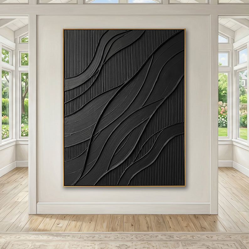 Minimalist black textured artwork displayed in a spacious, sunlit gallery room.