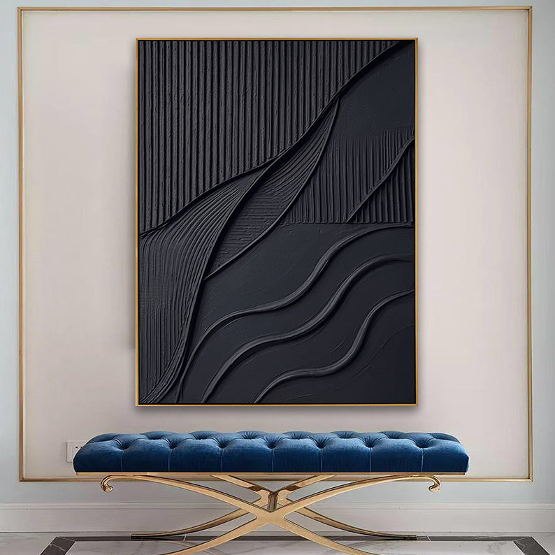 Large 3D black textured abstract painting hanging above a blue velvet tufted bench in a modern entryway.