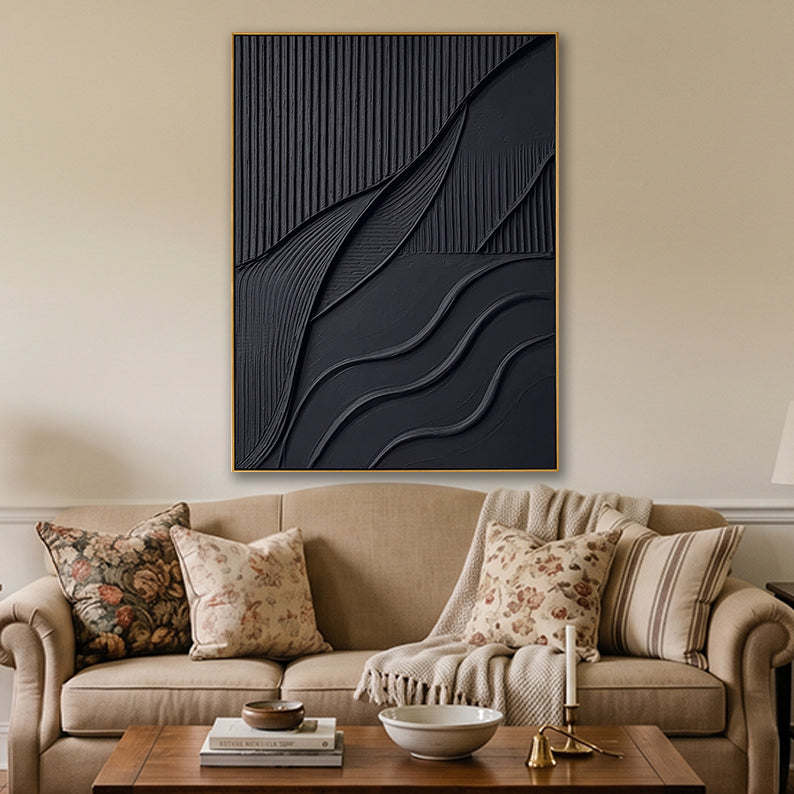 Sophisticated black textured canvas artwork styled in a cozy living room above a classic beige couch and floral cushions.