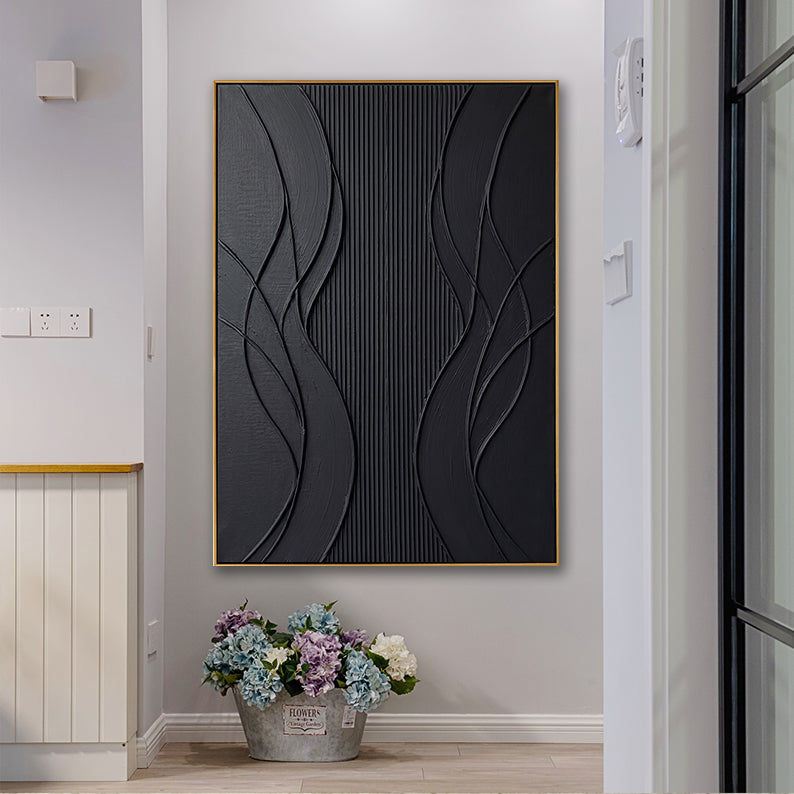 Black 3D impasto wall art styled in a bright modern home above a bucket of fresh flowers.