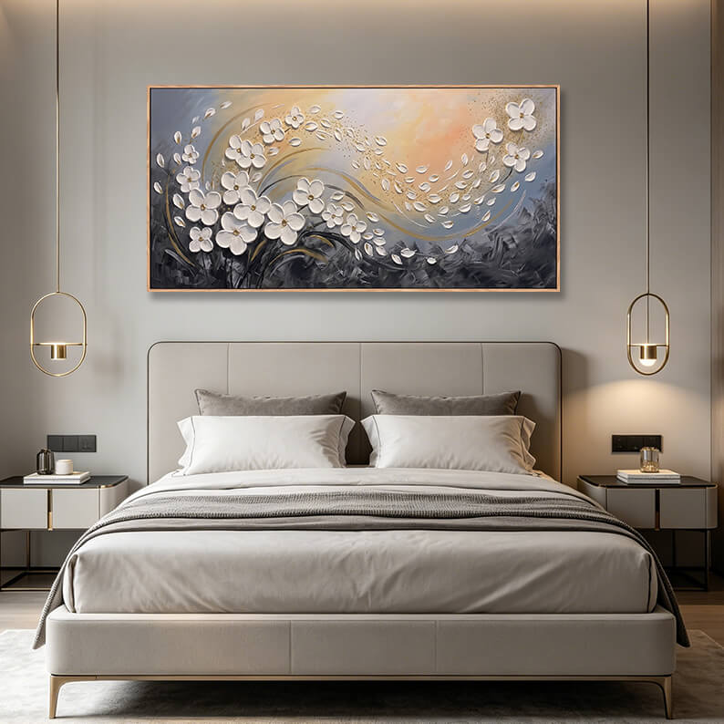 Panoramic white and gold blossom painting styled above a contemporary grey bed setup in a modern bedroom.