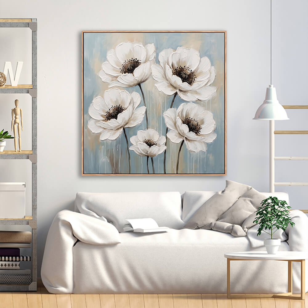 Textured white poppy floral artwork above white sofa in modern living room
